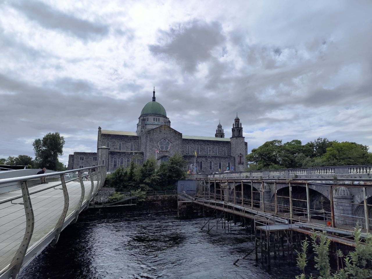 Catedral de Galway con su cúpula verde al fondo, entre dos puentes sobre el río Corrib